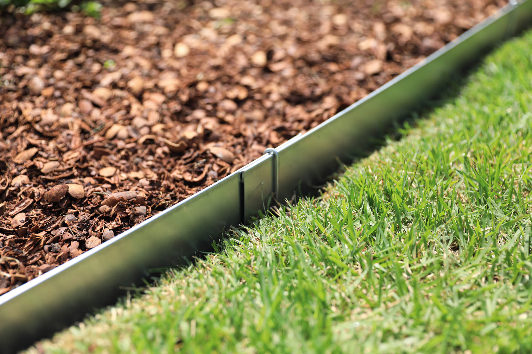 Place-and-Pin Steel Edging between mulch and grass